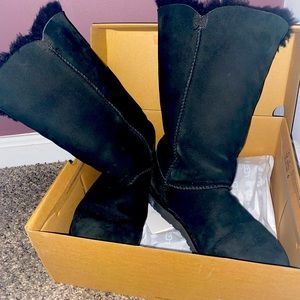 Tall black Ugg boots with button detail. Size 8. Comes with box.